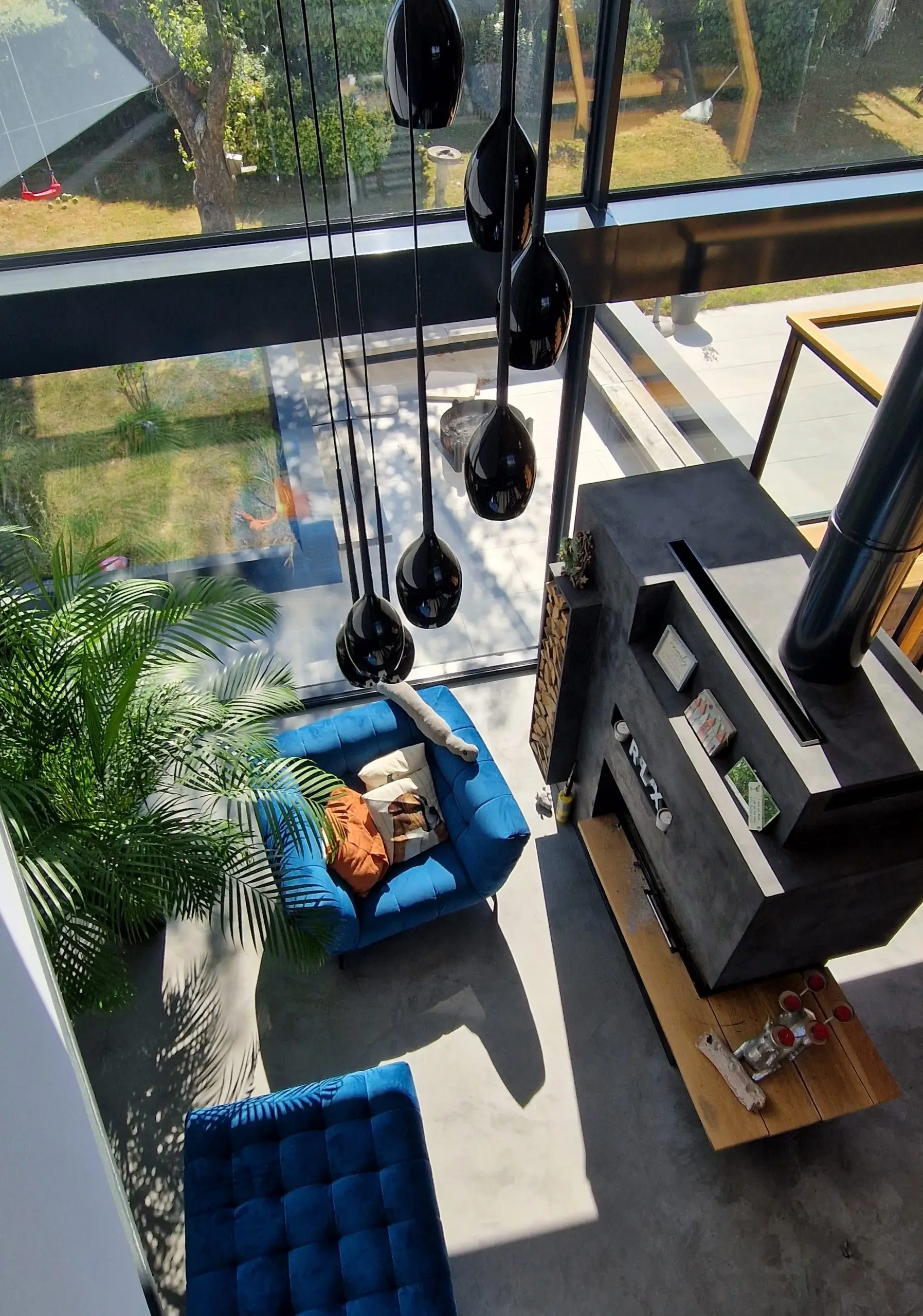 Dramatic shot from interior walkway looking to lounge and garden in luxury home